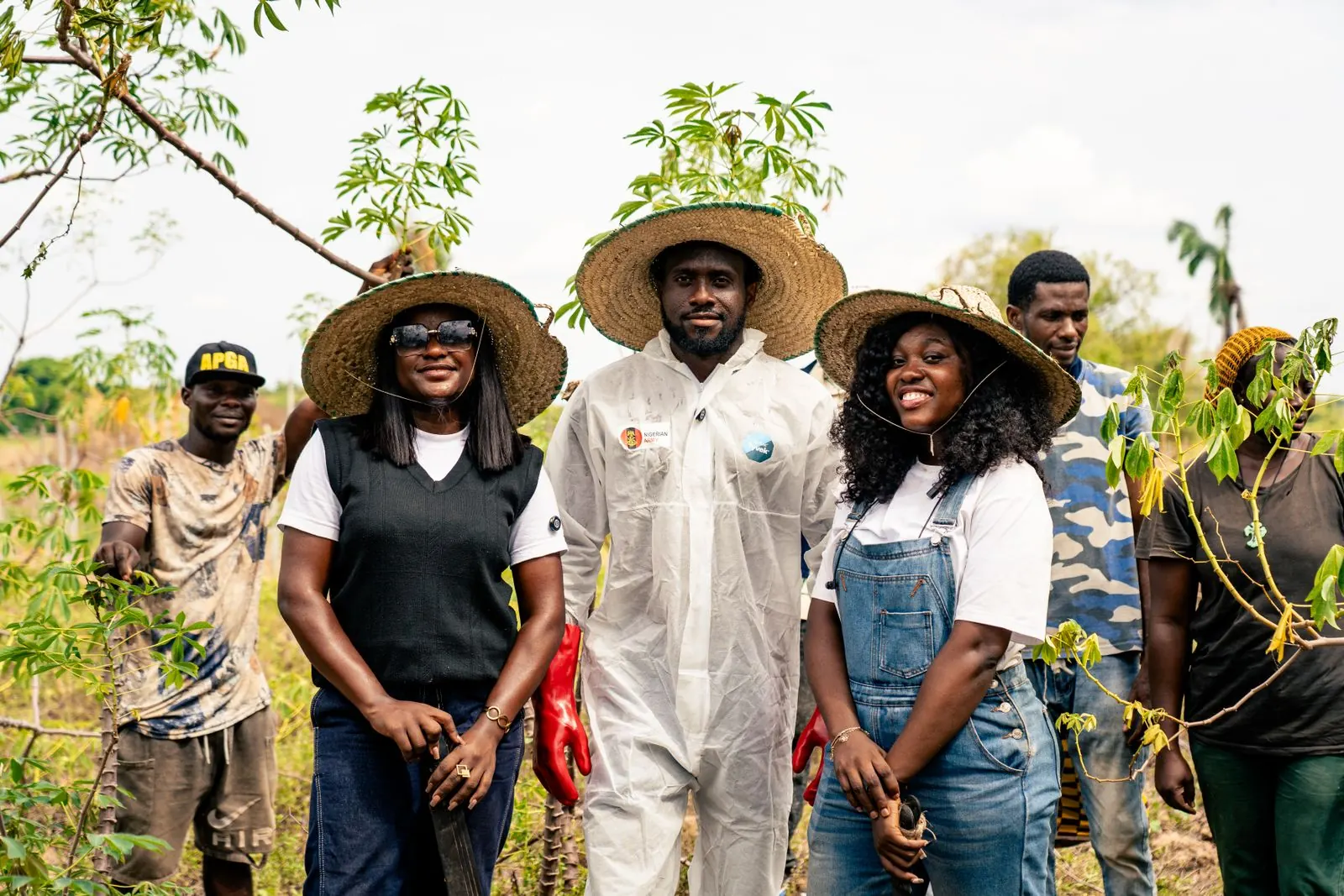Farmers standing together in a cassava field in Nigeria